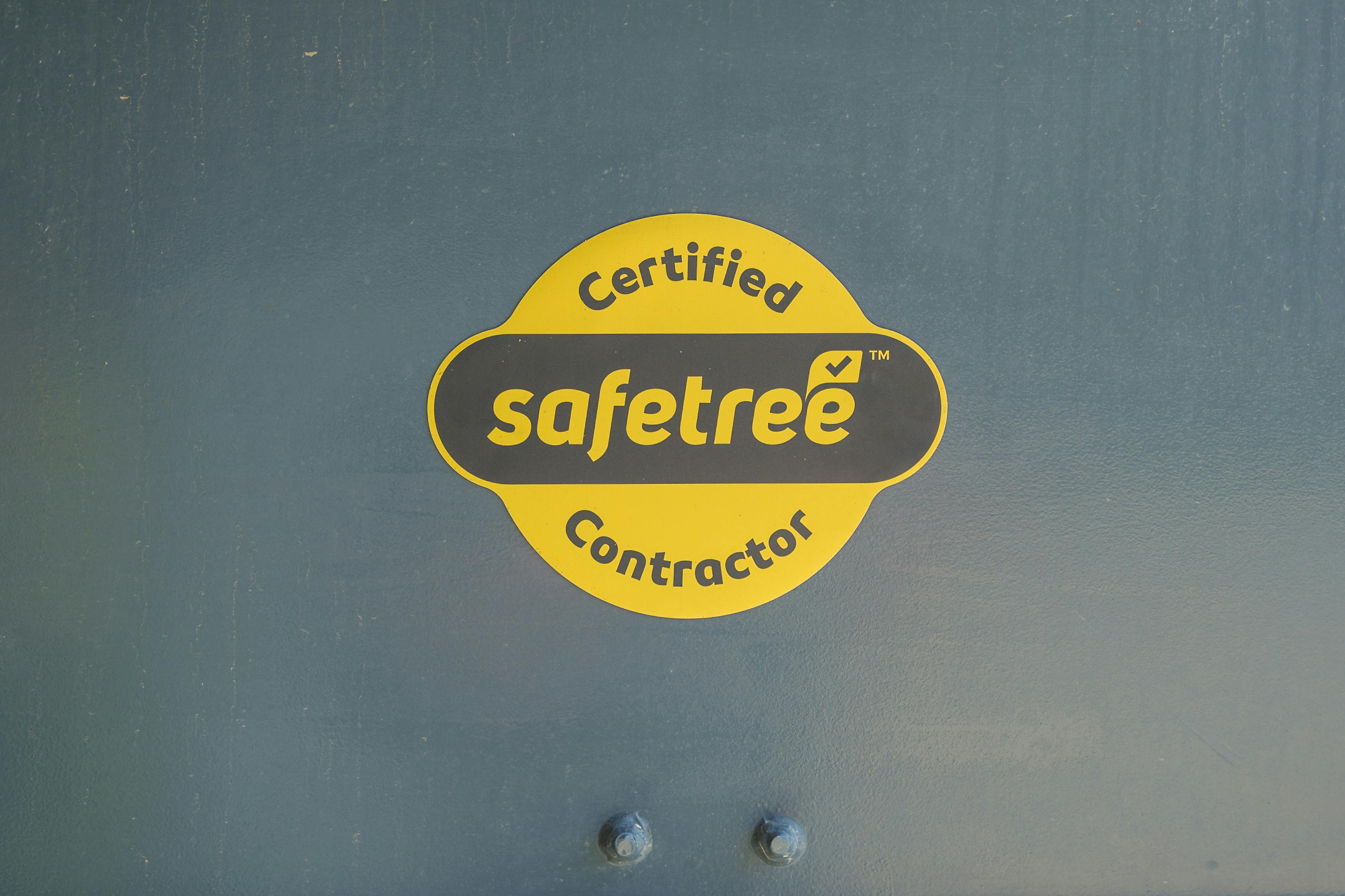 certified safetree contractor logo on metal background.